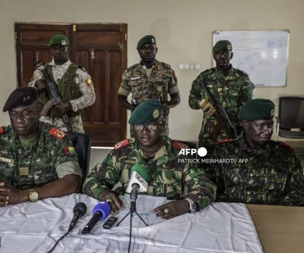 Brigadier General Denis N'Canha (C), head of the military office of the presidency gives a press conference at the General Staff of the Armed Forces on November 26, 2025. Gunfire was heard Wednesday outside Guinea-Bissau's presidential palace just three days after the country's presidential and legislative elections, with both major candidates have claimed victory, an AFP journalist on the scene witnessed.
People were seen running in a crowd gathered outside the palace as the shots were heard. (Photo by Pat