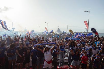 Supporters celebrate Cape Verdes victory against Eswatini during the FIFA World Cup 2026 Africa qualifiers group D match at a fan zone in Sao Vicente, Cape Verde, on October 13, 2025. A carnival-like atmosphere erupted in the streets of Cape Verde on Monday after the tiny archipelago nation qualified for the first time ever for the World Cup. Located off the coast of Senegal, it is the country with the smallest population to represent Africa in the global showpiece, with just 550,000 inhabitants. (Photo by QUEILA FERNANDES / AFP)