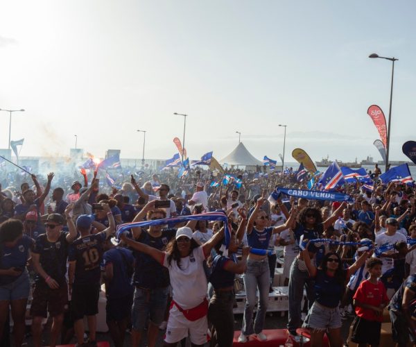 Supporters celebrate Cape Verdes victory against Eswatini during the FIFA World Cup 2026 Africa qualifiers group D match at a fan zone in Sao Vicente, Cape Verde, on October 13, 2025. A carnival-like atmosphere erupted in the streets of Cape Verde on Monday after the tiny archipelago nation qualified for the first time ever for the World Cup. Located off the coast of Senegal, it is the country with the smallest population to represent Africa in the global showpiece, with just 550,000 inhabitants. (Photo by QUEILA FERNANDES / AFP)