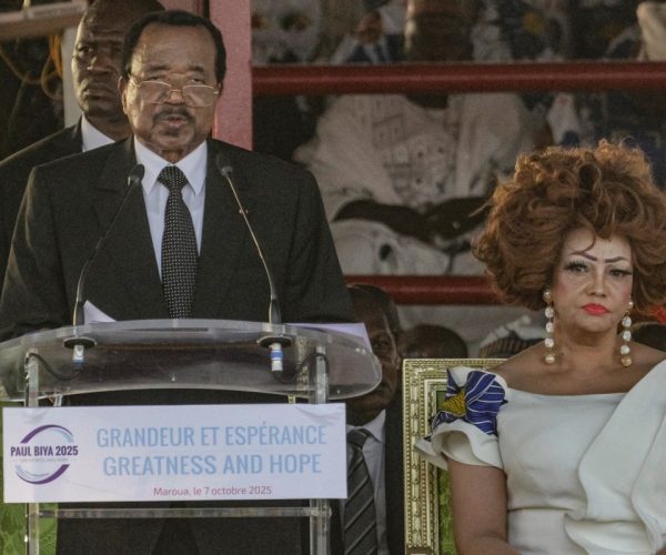 (FILES) Cameroon incumbent President Paul Biya flanked by his wife, Cameroon First Lady Chantal Biya (R), addresses a campaign rally in Maroua on October 7, 2025. Cameroon's President Paul Biya, the world's oldest head of state at age 92, was sworn in for his eighth term on November 6, 2025. (Photo by ROBERT FIMBAYE / AFP)