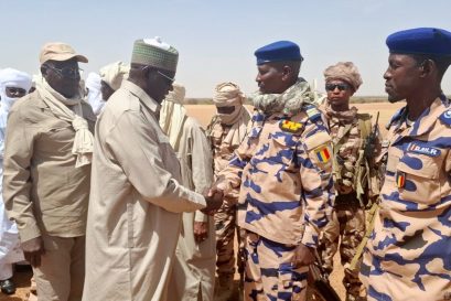 In this photo release by the Chadian Press Agency, Limane Mahamat, deputy prime minister, center left, is greeted upon his arrival at Igote village following a clash between two families over a water point, in the Wadi Fira, Chad, Sunday, April 26, 2026. (Chadian Press Agency via AP)