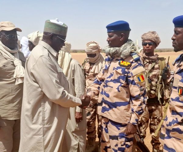In this photo release by the Chadian Press Agency, Limane Mahamat, deputy prime minister, center left, is greeted upon his arrival at Igote village following a clash between two families over a water point, in the Wadi Fira, Chad, Sunday, April 26, 2026. (Chadian Press Agency via AP)