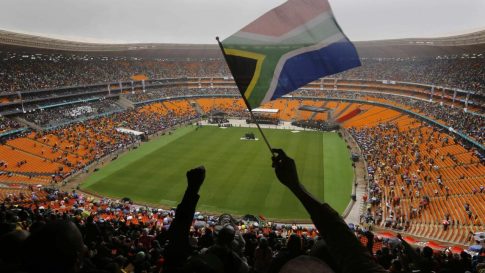 A man waves a South African flag during a memorial service for former South African President Nelson Mandela at the First National Bank (FNB) Stadium, also known as Soccer City, in Johannesburg December 10, 2013. World leaders from U.S. President Barack Obama to Cuba's Raul Castro joined thousands of South Africans to honour Mandela on Tuesday in a memorial that will celebrate his gift for uniting enemies across political and racial divides. REUTERS/Yannis Behrakis (SOUTH AFRICA - Tags: POLITICS OBITUARY TPX IMAGES OF THE DAY)